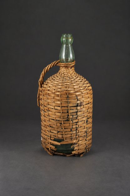 Botellón de vidrio soplado con cestería  Ca 1950