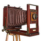Cámara de fuelle roja con tripie. Decorativa, no funciona. Ca. 1905–1925. Antiguo.